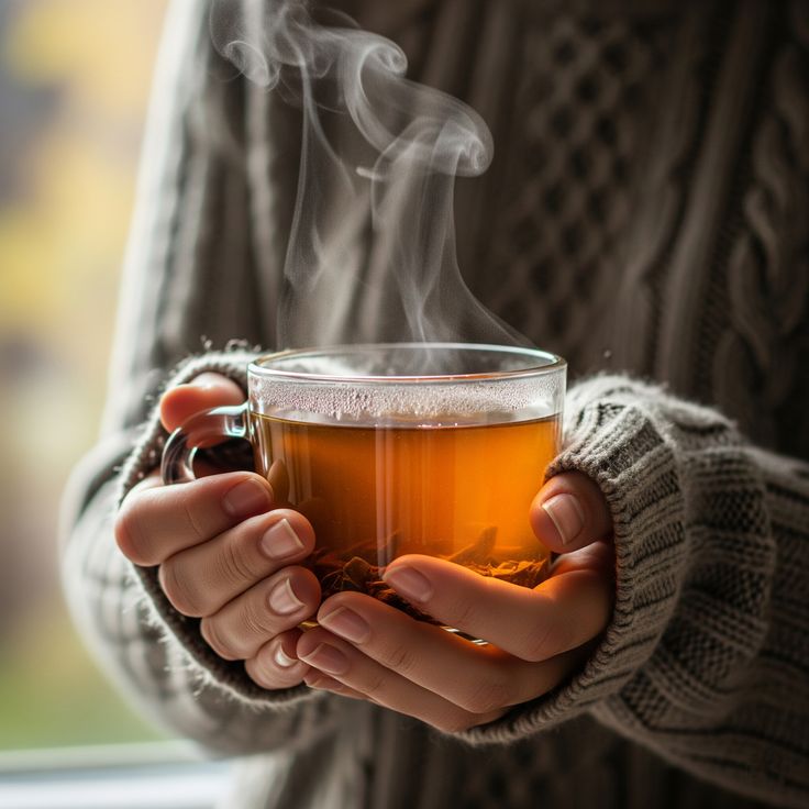 Illustration of a warm herbal infusion in a ceramic cup with steam